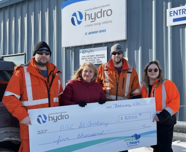 Three Hydro employees stand in front of the St. Anthony office with an employee of Boys and Girls Club. They are holding a large cheque for $5,000