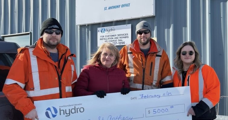 Three Hydro employees stand in front of the St. Anthony office with an employee of Boys and Girls Club. They are holding a large cheque for $5,000