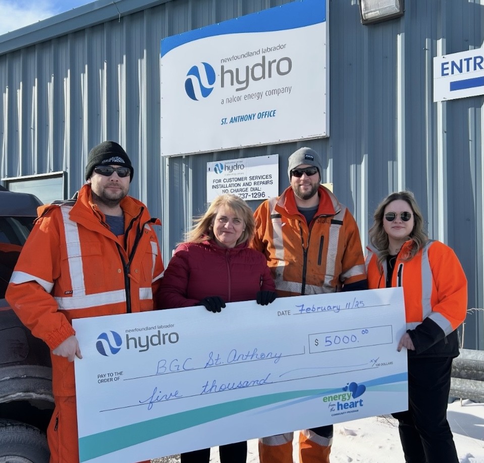 Three Hydro employees stand in front of the St. Anthony office with an employee of Boys and Girls Club. They are holding a large cheque for $5,000