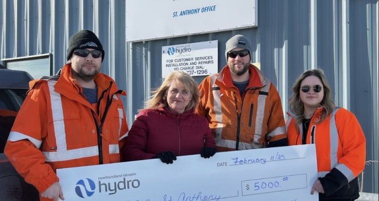 Hydro employees holding a life-size $5000 donation cheque to the St. Anthony Boys and Girls Club
