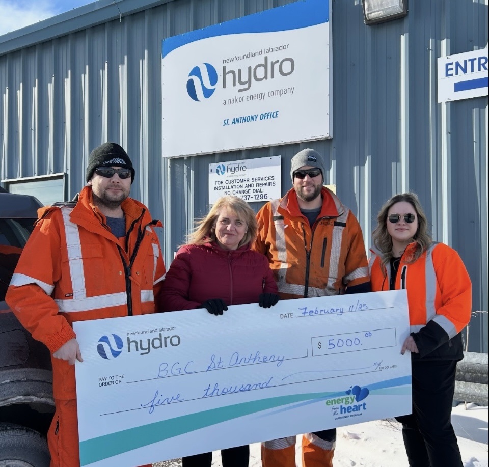 Hydro employees holding a life-size $5000 donation cheque to the St. Anthony Boys and Girls Club